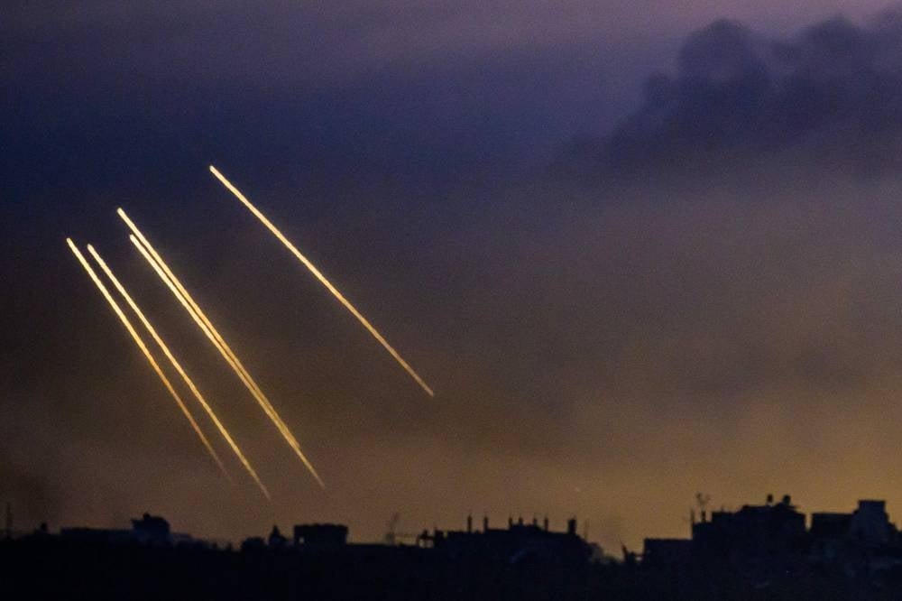 This long exposure picture taken from southern Israel near the border with the Gaza Strip shows Israeli smoke ammunition fired by Israeli troops on the northern part of the Palestinian enclave on Nov 22. Photo by John Macdougal/AFP