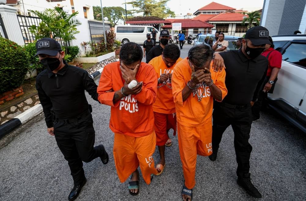 R. Gunasellan, 52, (second from right) R. Anandan, 35, (second from left) and A.F. Adrian Raj Dominic, 29, (centre) pleaded not guilty to the charge before Judge Rohaida Ishak. Photo by Bernama