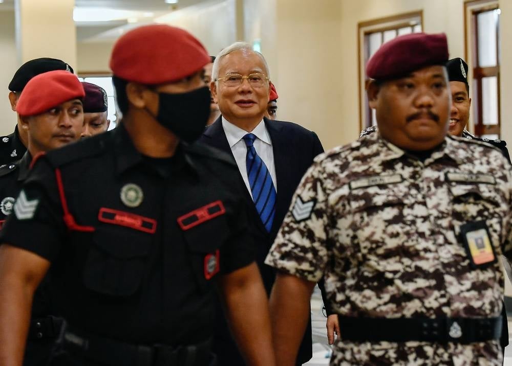Former prime minister Datuk Seri Najib Razak (middle) at the Kuala Lumpur High Court, today for his money laundering case involving SRC International Sdn Bhd (SRC) funds totalling RM27 million. - Photo by Bernama
