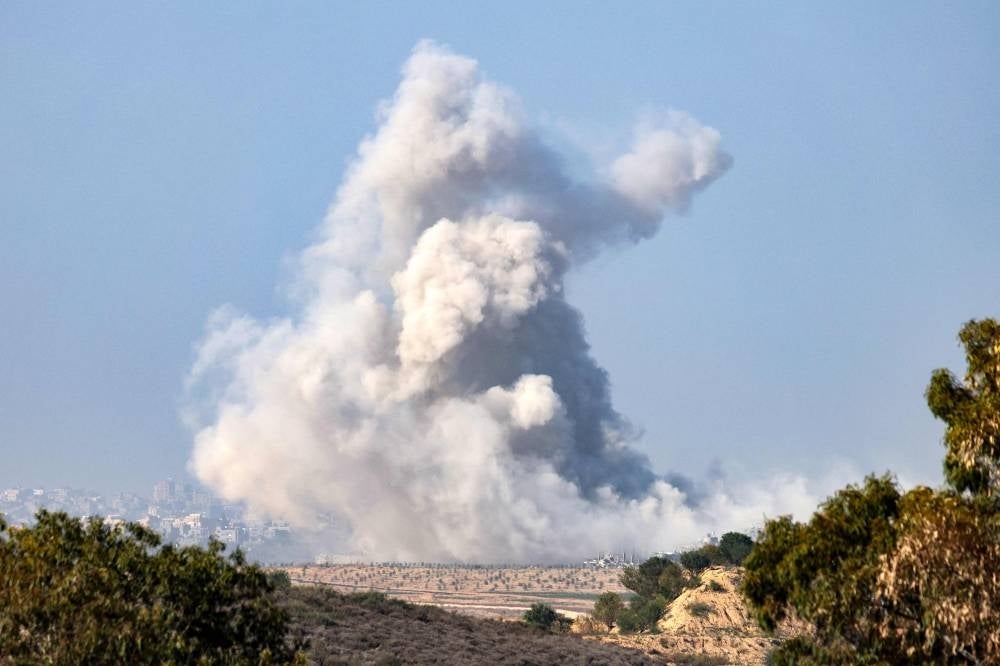 This picture taken from southern Israel near the border with the Gaza Strip shows smoke rising from the northern Gaza Strip during Israeli strikes, as battles resumed between Israel and Hamas - AFP 