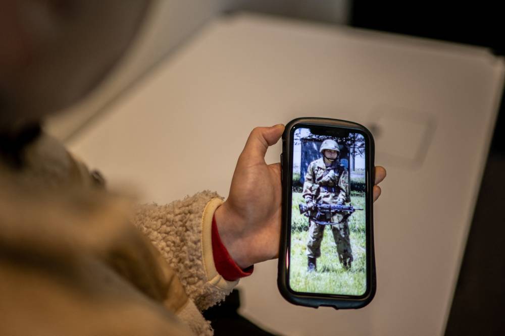 Rina Gonoi, a former member of Japan's Ground Self-Defence Force who was sexually assaulted by colleagues, checking old photos on her phone during an interview with AFP in Tokyo. - AFP FILE PIX 