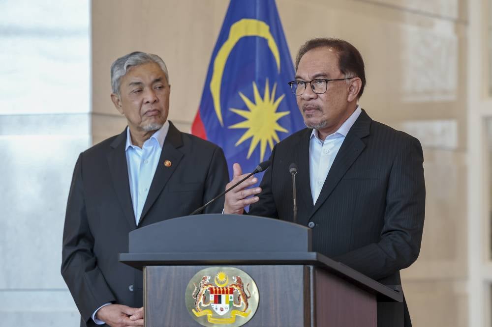 Prime Minister Datuk Seri Anwar Ibrahim at the press conference announcing the new cabinet at Bangunan Perdana Putra, today. Also present was Deputy Prime Minister Datuk Seri Ahmad Zahid Hamidi (left). - Photo by Bernama