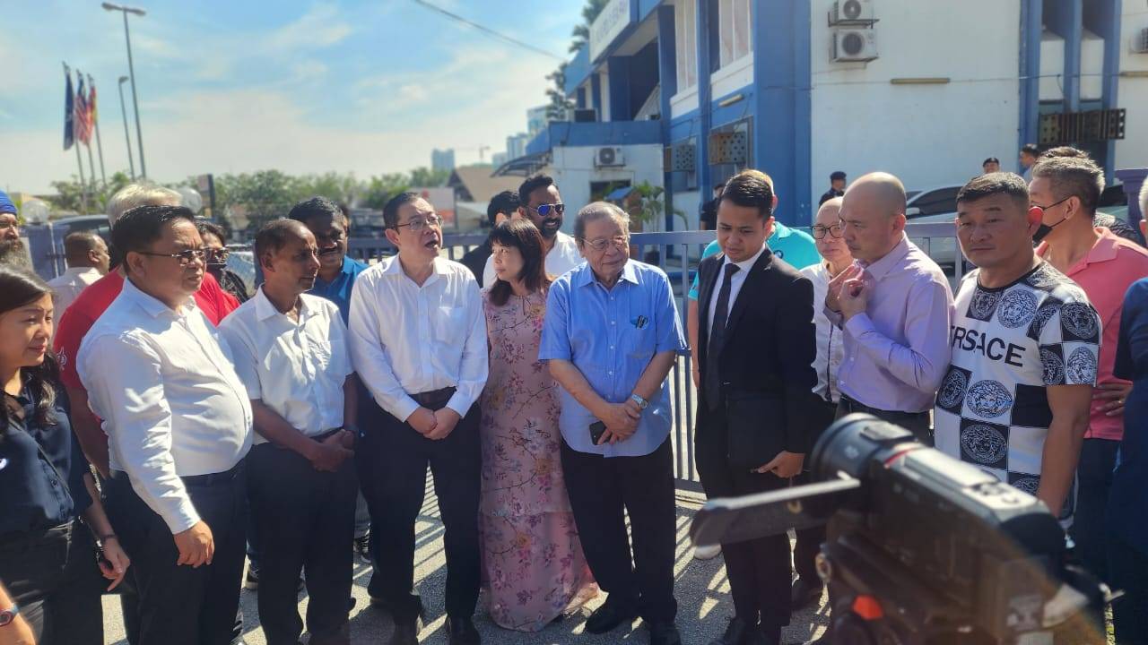 Kit Siang (four, right) represented by his lawyer Khairil Khalid (three, right) at the Sea Park police station, Petaling Jaya, on Wednesday.