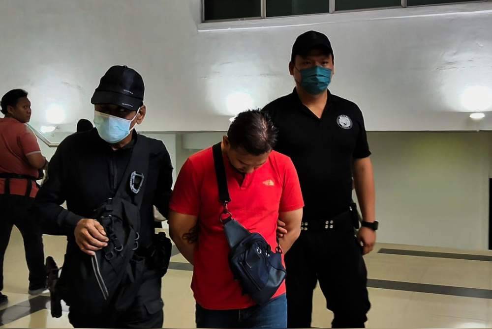 Izzat Saat who allegedly hit his wife with a dumbbell, was charged in the Magistrate’s Court today, with murdering the woman.