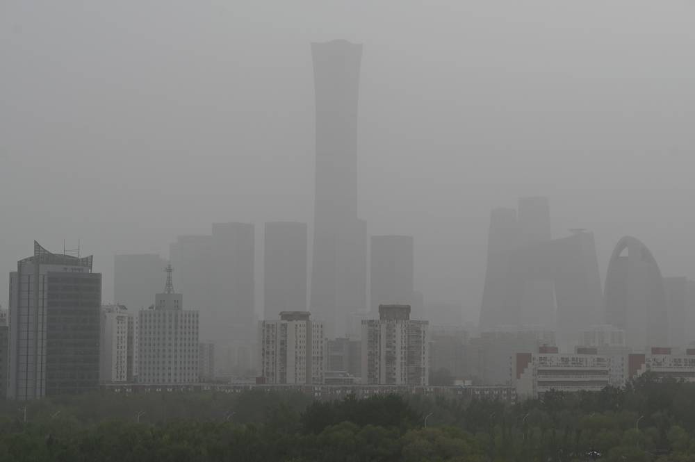 (FILES) High rise buildings at central business district are seen on a severely polluted day in Beijing on April 12, 2023. China's air pollution worsened in 2023, the first time it has done so in a decade, a study released on December 22, 2023 said. - Photo by AFP