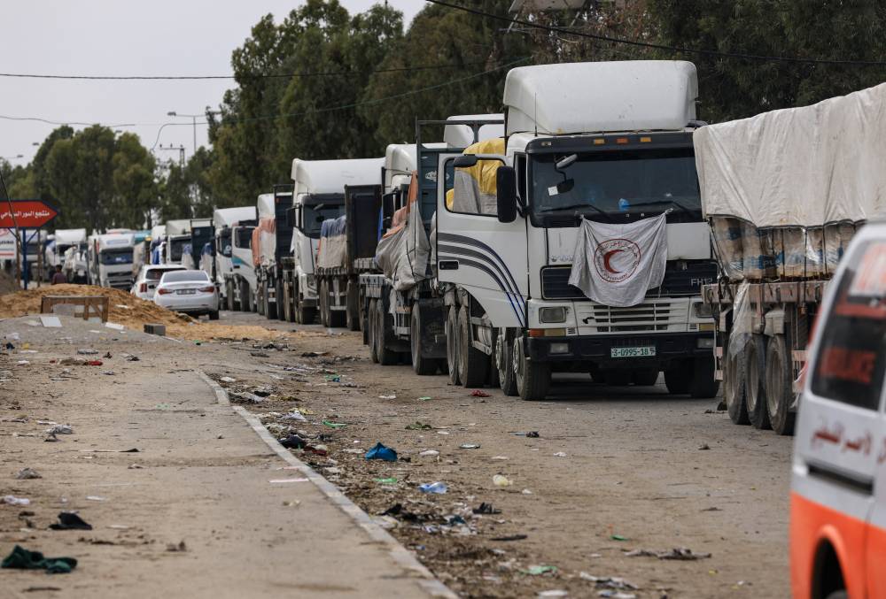 A convoy of trucks carrying fuel and aid drive in Gaza City's Zeitoun district on Nov 25, 2023, on the second day of a truce between Israel and Hamas. - (Photo by MAHMUD HAMS / AFP)