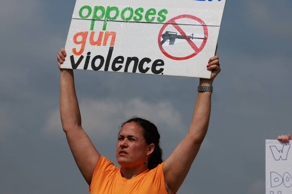 People protest against gun violence outside of the Cotton wood Creek Baptist Church on May 7, 2023 in Allen, Texas.- Photo by AFP