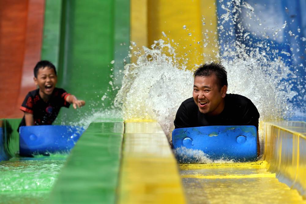 Parents spending time with their children at WaterWold I-City. Photo by Bernama