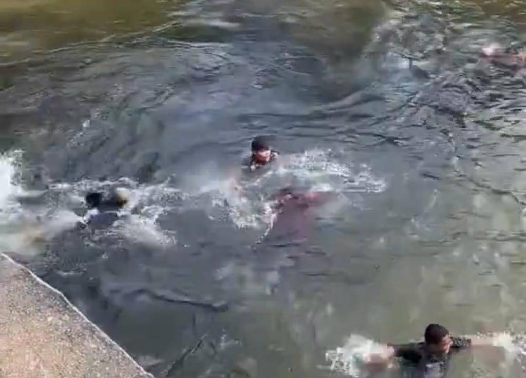 A screenshot of a video of a girl who nearly drowned after her headscarf was seen covering her face. - Photo: X