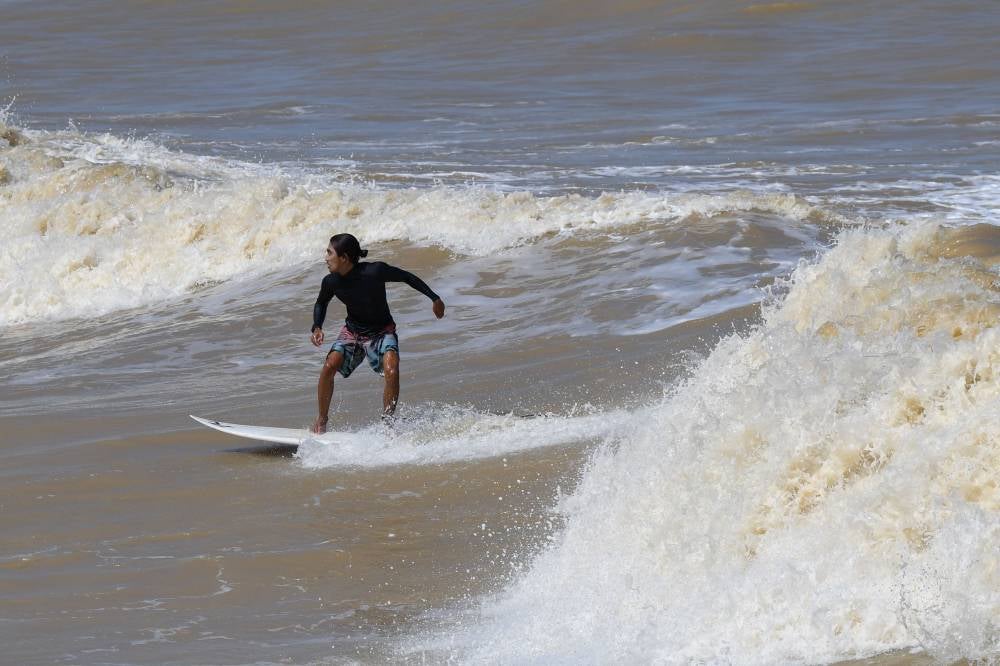 A surfer from Kemasin Surfing Club (KSC) riding the waves at Pantai Kemasin recently. Photo by Bernama