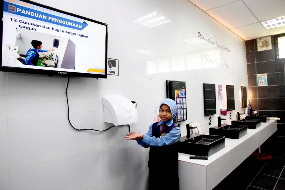 Student Nur Mirza Zhafrisya Abdul Rahman, 9, using the toilet facilities at Sekolah Kebangsaan Tanah Hitam.