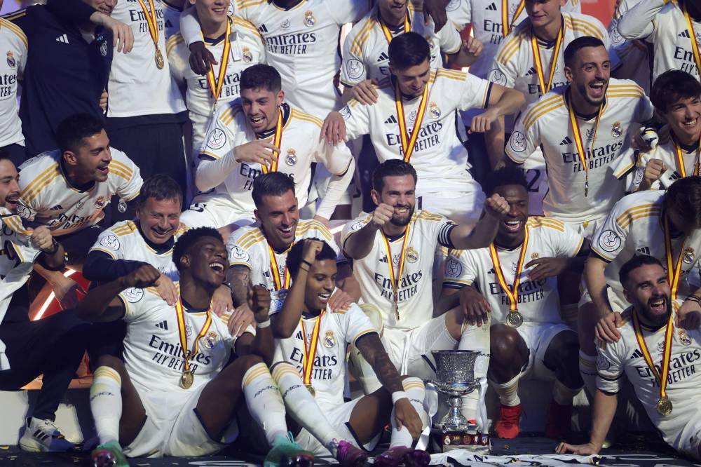 Real Madrid's Spanish defender and captain #06 Nacho Fernandez and his teammates celebrate with the trophy after winning the Spanish Super Cup final football match against Barcelona at Al-Awwal Park Stadium in Riyadh, on January 14, 2024. - Photo by AFP