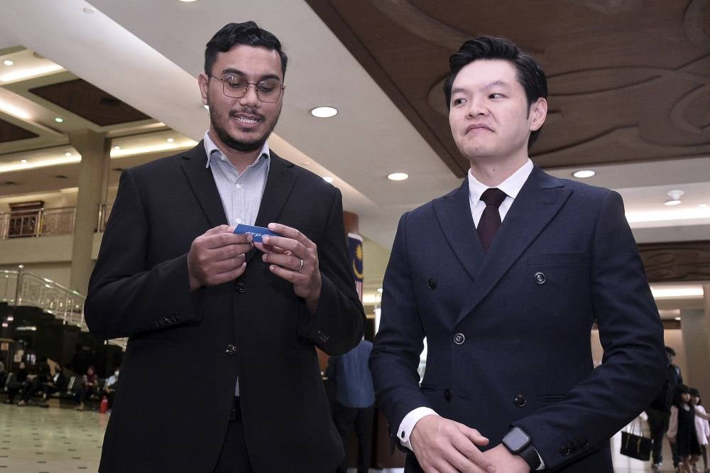 Mentega Terbang director and scriptwriter Mohd Khairianwar Jailani, 32, (left) and the film's producer Tan Meng Kheng were charged with deliberate intention of wounding the religious feelings of others at the magistrate's court, today. - Photo by Bernama