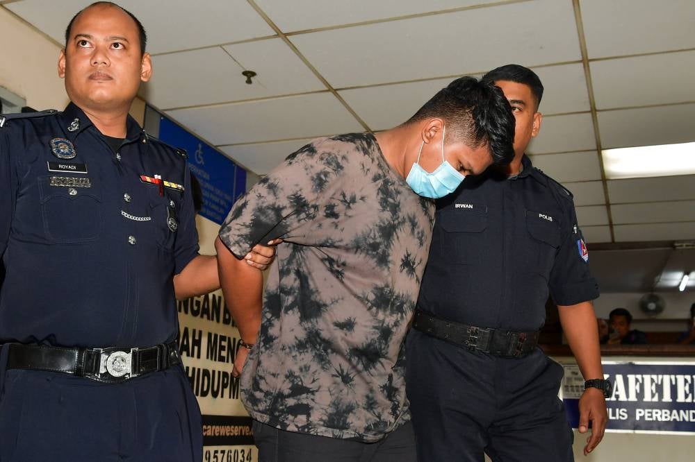 Constable Muhammad Adib Aikal Sharul Nizam being brought to the Ampang sessions court today. - Photo by Bernama