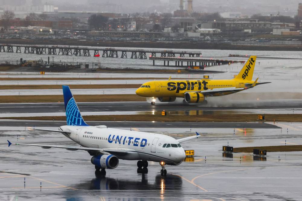 An Airbus A320 passengers aircraft of Spirit airlines arriving from Miamia is pictured while an Airbus A319 of United airlines arrived from Denver are seen at La Guardia Airport on Jan 9, 2024. - (Photo by CHARLY TRIBALLEAU / AFP)