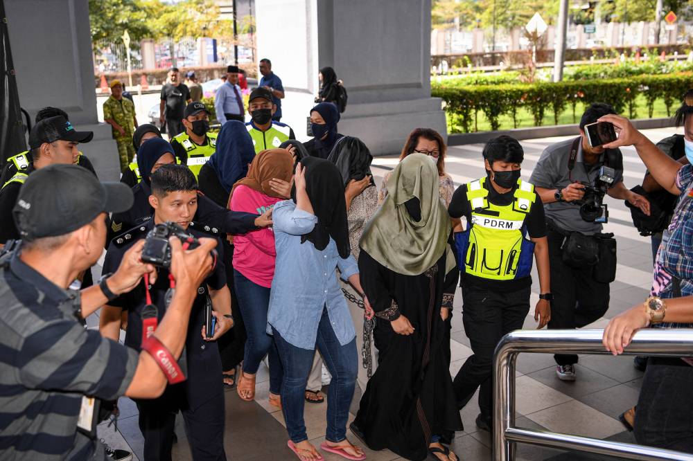 Four out of the six women linked to the 'Hot Daddy' videos on app X were each fined between RM2,500 and RM4,800 by three Magistrates' Courts here today for possessing pornographic videos on their mobile phones and devices. - Photo by Bernama