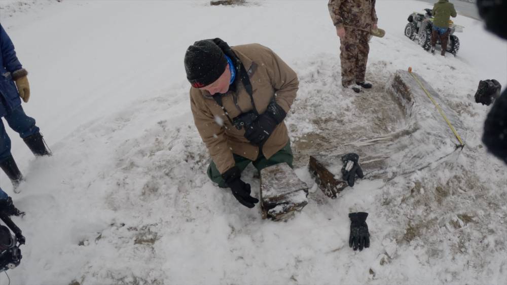 Neil Burgess, president of Shipwreck Preservation Society Of Newfoundland and Labrador, a non-profit organisation which promotes the preservation of shipwrecks throughout the province, explains how you can see the rings of a tree on this piece of wood from the wreckage on February 3, 2024 in Cape Ray, Newfoundland and Labrador, Canada. - Photo by AFP