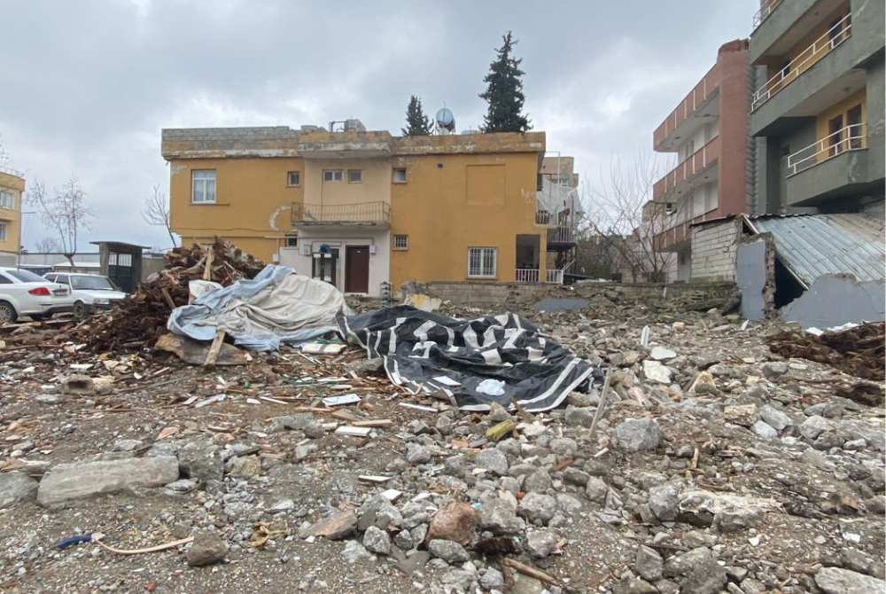 An empty site scattered with some rubble. 