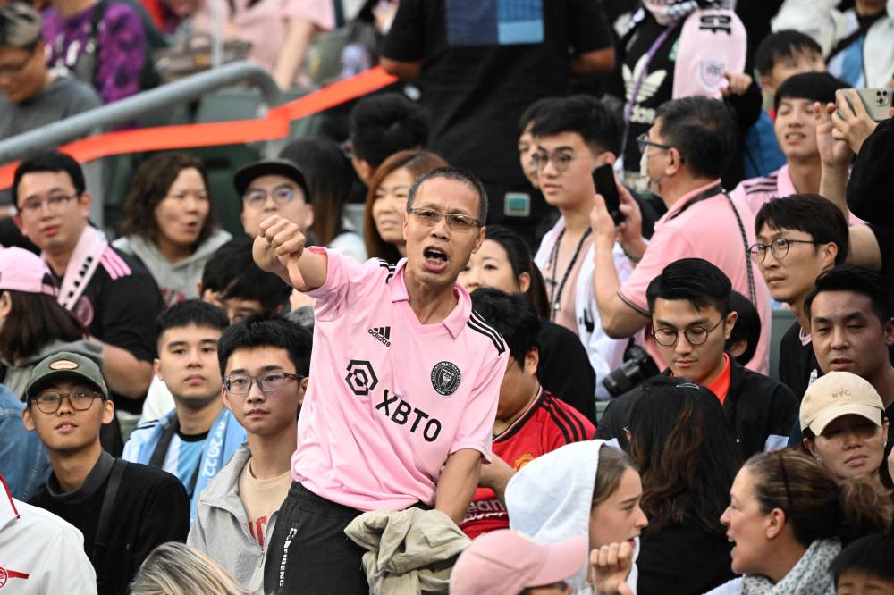 Fans react after not seeing Inter Miami's Argentine forward Lionel Messi play after the friendly football match between Hong Kong XI and US Inter Miami CF in Hong Kong on February 4, 2024. Inter Miami were booed off the pitch after their injured superstar Lionel Messi failed to take the field in a pre-season friendly in Hong Kong. - Photo by AFP