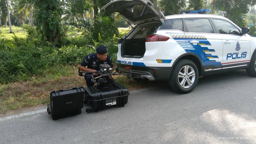 Police using a drone to monitor the aircraft crash location in Kampung Tok Muda, Kapar on Tuesday. - Photo by Sinar