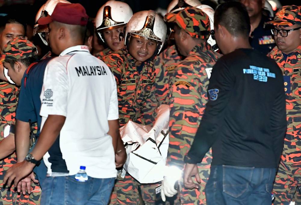 The Fire and Rescue Department brought out the body of one of the two victims of the BK160 Gabriel light plane crash that crashed in Kampung Tok Muda here this afternoon. Photo by Bernama