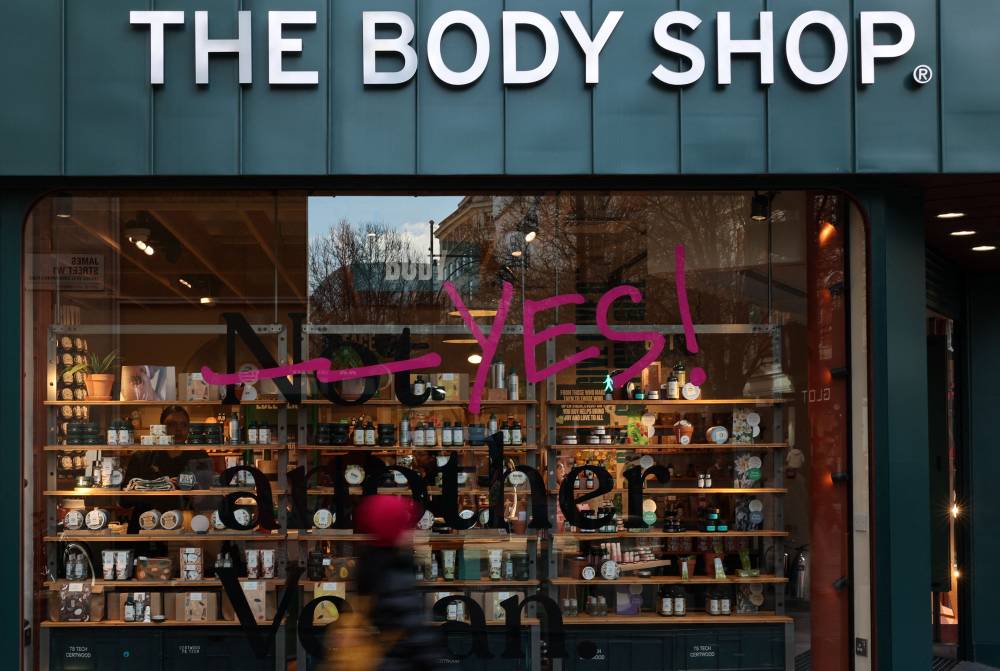 Pedestrians walk bas a branch of The Body Shop in central London on February 12, 2024. The Body Shop, the near 50-year-old cosmetics company renowned for its ethical hair and skin products, is near bankrupt in the UK after poor Christmas trade, according to reports in British media. - Photo by AFP