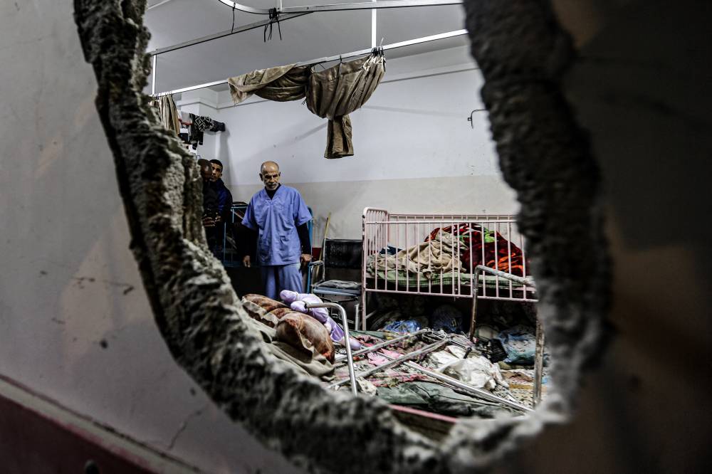 (FILES) People inspect the damage in a room following Israeli bombardment at Nasser hospital in Khan Yunis in the southern Gaza Strip on Dec 17, 2023. - Photo by AFP