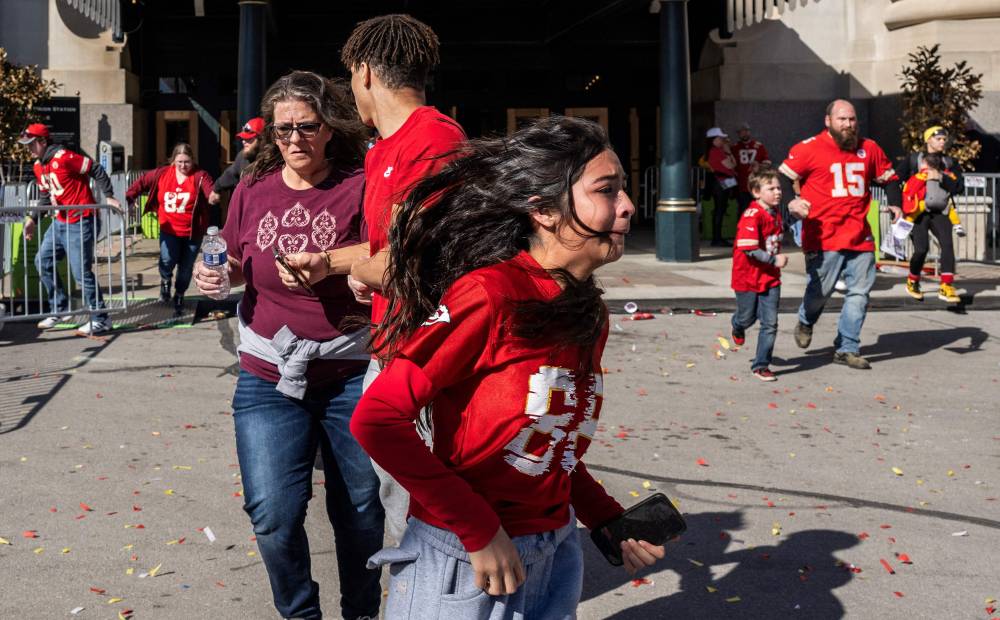 People flee after shots were fired near the Kansas City Chiefs' Super Bowl LVIII victory parade on Feb 14, 2024, in Kansas City, Missouri. (Photo by ANDREW CABALLERO-REYNOLDS / AFP)