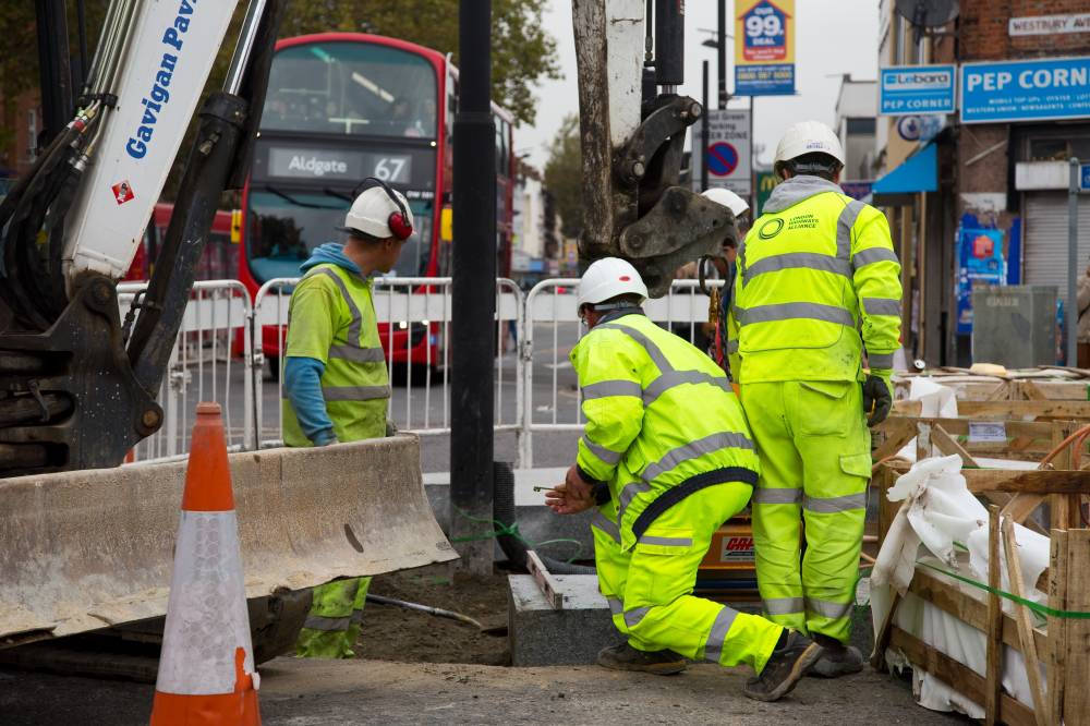 Workmen using a sprobst vacuum stone magnet by Turnpike lane station on Oct 11, 2014 in London, England. (123rf)