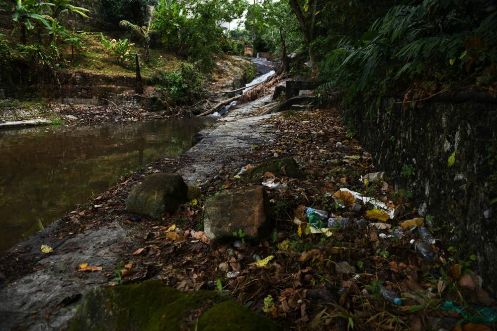 The site where former Prime Minister Tun Abdullah Ahmad Badawi enjoyed swimming during his childhood is marred by rubbish, and the once-clear water is now murky and polluted. - Photo by Bernama