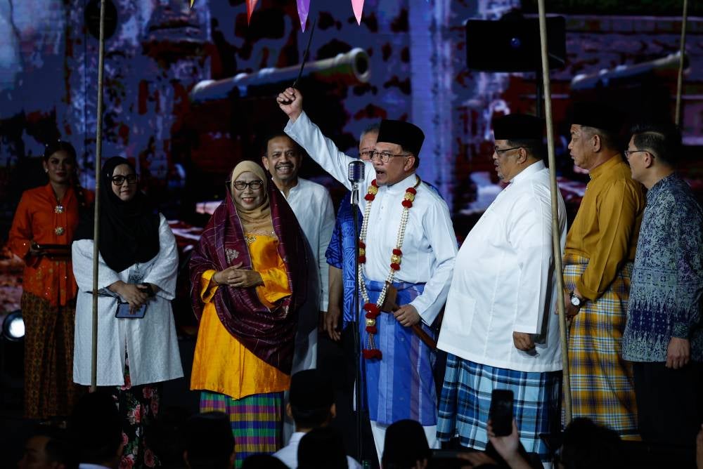 Prime Minister Datuk Seri Anwar Ibrahim, portraying Tunku Abdul Rahman, raises the Sapukal Keris during the Celebration of the Proclamation of Independence of the Federation of Malaya Date at the Independence Memorial on Feb 20 in Melaka. (BERNAMA PHOTO) 