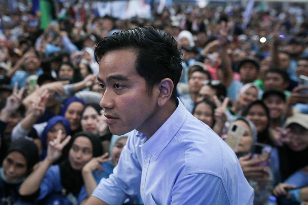 Vice presidential candidate Gibran Rakabuming Raka, Indonesian President Joko Widodo's son and current Surakarta City mayor, attends an election campaign at the Gelora Bandung Lautan Api Stadium in Bandung, West Java, on Feb 8, 2024. - (Photo by ADITYA AJI / AFP)