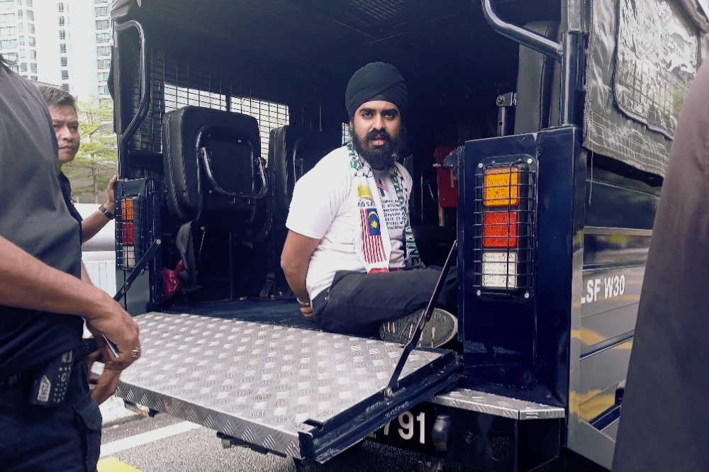 PSM member Harmit Singh was briefly detained by the police on Feb 24 while gathering near the US Embassy to deliver a memorandum calling for the liberation of Palestine. Photo: PSM Facebook page. 