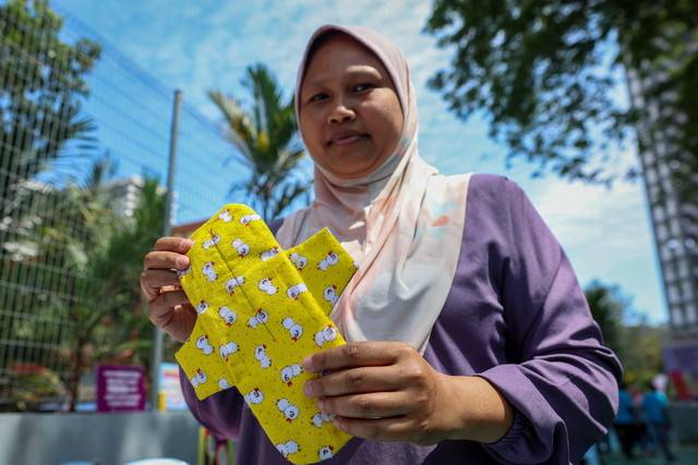 Seamstress Fadilah Ali who has 15 years of experience sewing traditional and modern garments for men and women now plans to make and sell her own line of affordable and eco-friendly reusable sanitary towels. - Photo by Bernama