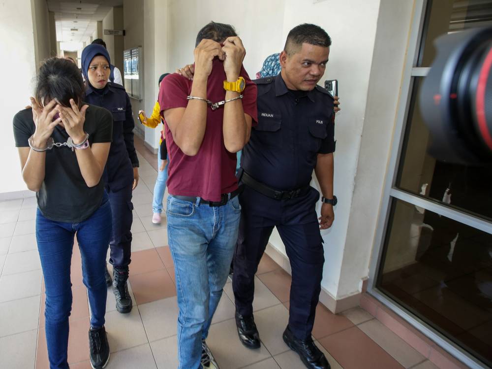 A woman (left) pleaded guilty in the Sessions Court today to a charge of abusing her 16-month-old son by giving him milk mixed with liquid Methamphetamine. - Photo by Bernama
