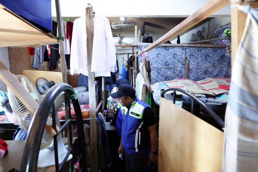 Labour Department and several agencies conducting Ops Mega Gegar operation yesterday. - Photo by Bernama