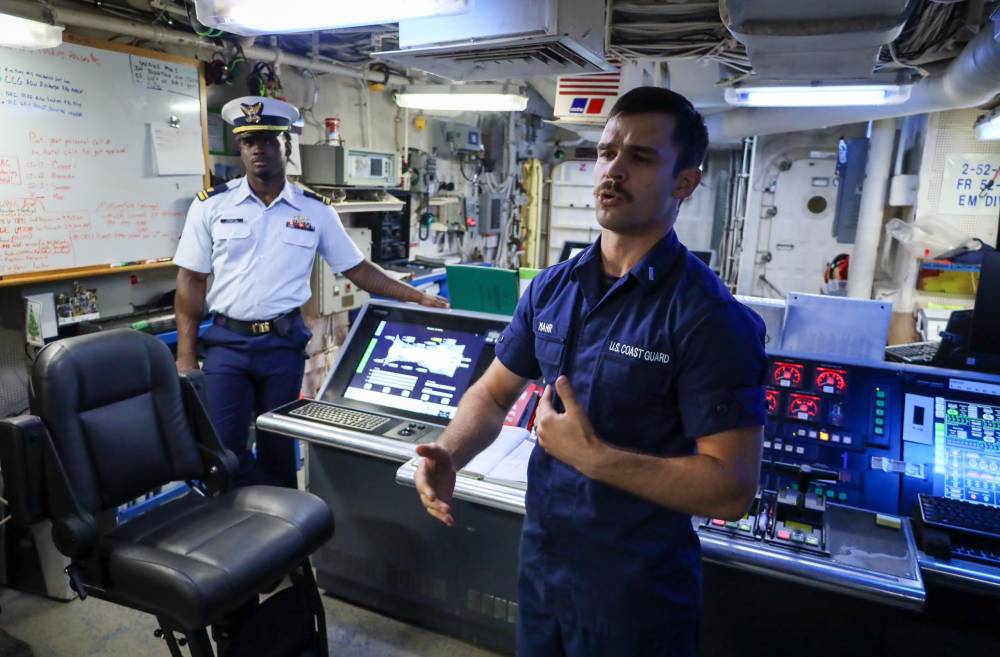 United States Coast Guard crew giving a tour of the vessel to members of media 