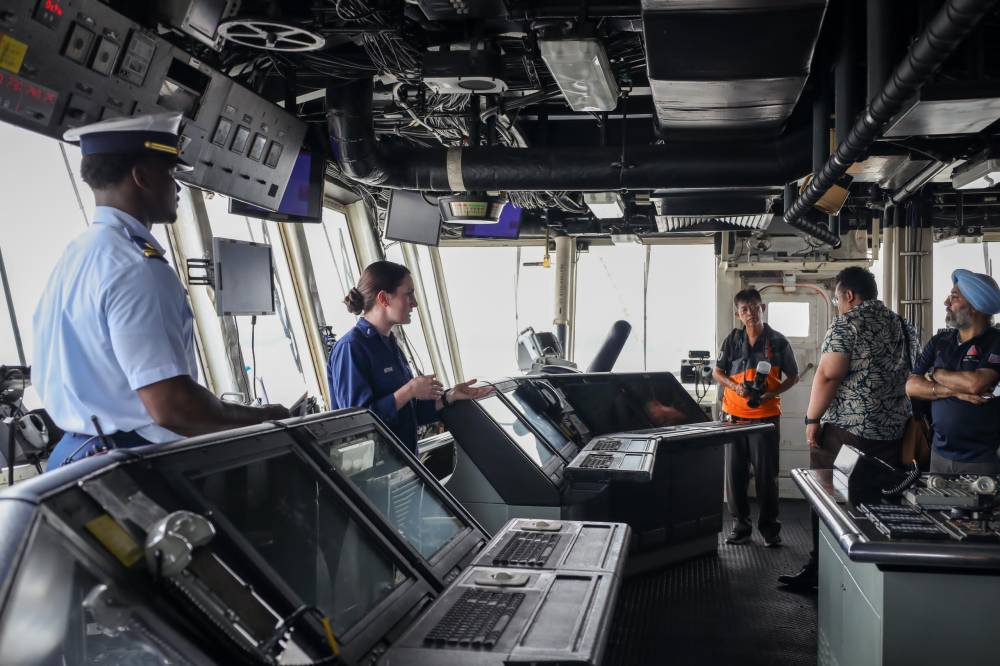 United States Coast Guard crew giving a tour of the vessel to members of media 