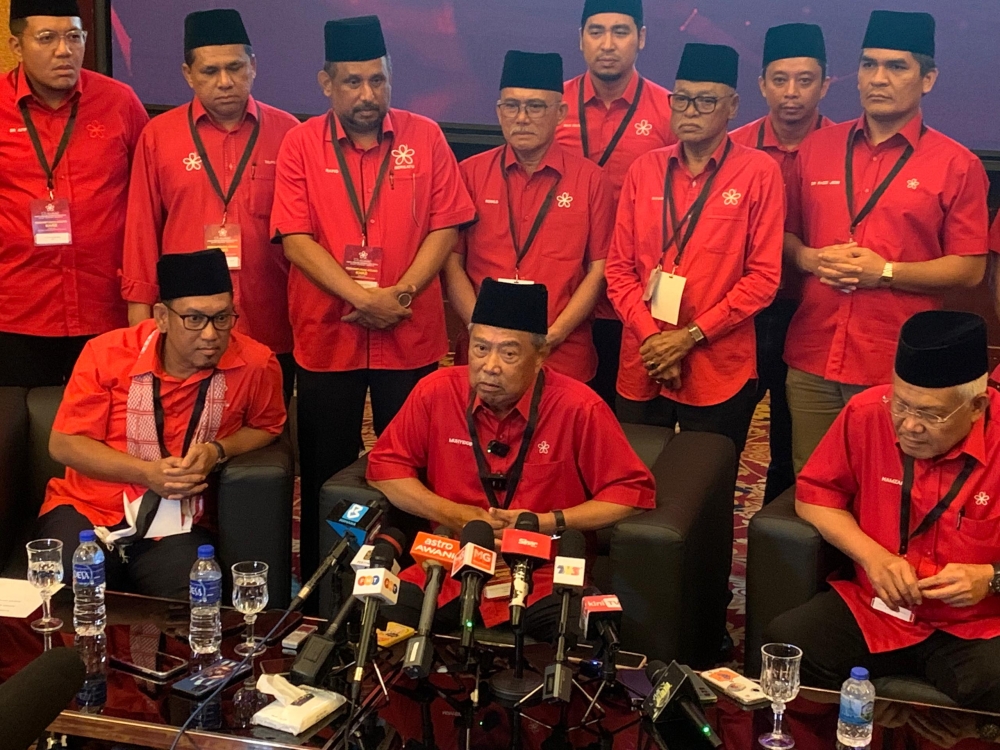 Muhyiddin (sitting, centre) at a press conference after the Bersatu&#039;s Extraordinary General Meeting (EGM) at the Ideal Convention Centre Selayang on Saturday.