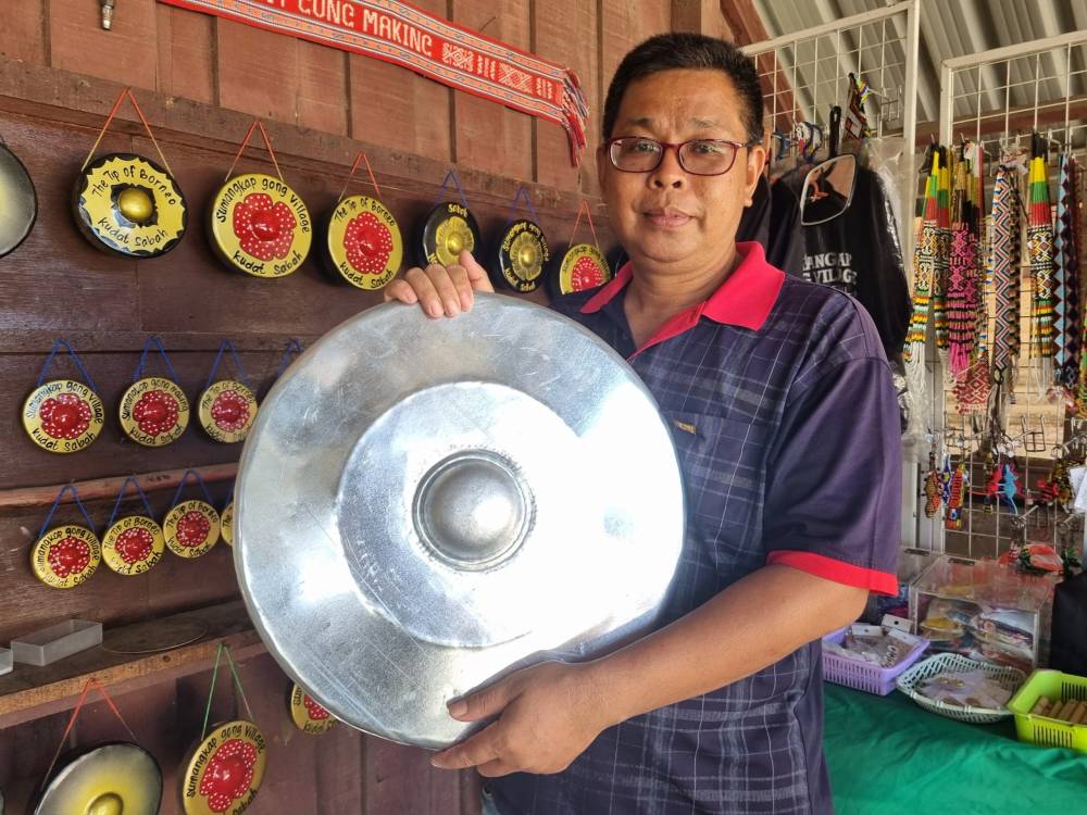 Third-generation gong maker Ronny Makuut, 44, said the gong-making in the village started in the 1950s following a dream by a village elderly for residents to make the gong to ensure the well-being of the village. - Photo by Bernama