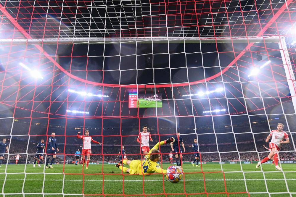 Bayern Munich's English forward #09 Harry Kane (R) scores the 3-0 past Lazio's Italian goalkeeper #94 Ivan Provedel during the UEFA Champions League round of 16, second-leg football match between FC Bayern Munich and Lazio in Munich, southern Germany on March 5, 2024. Photo by AFP