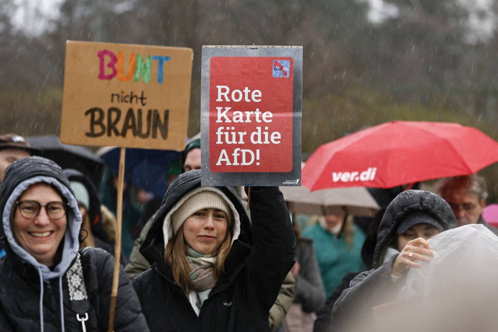 People demonstrate in defence of democracy and protest against racism and the far-right Alternative for Germany (AfD) party on February 25, 2024 in Hamburg. (Photo by MORRIS MAC MATZEN / AFP)