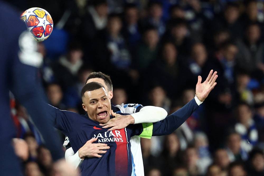 Paris Saint-Germain's French forward #07 Kylian Mbappe vies with Real Sociedad's Spanish midfielder #05 Igor Zubeldia during the UEFA Champions League last 16 second leg football match between Real Sociedad and Paris Saint-Germain (PSG) at the Anoeta stadium in San Sebastian on March 5, 2024. (Photo by FRANCK FIFE / AFP)