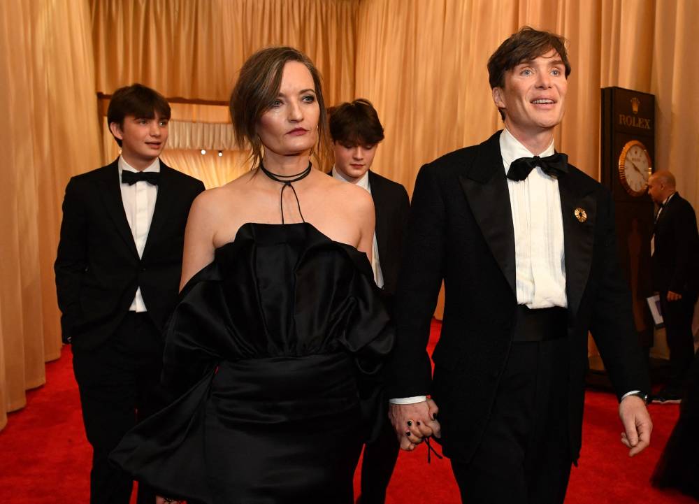 Irish actor Cillian Murphy arrives with guests (wife Yvonne McGuinness and two sons) at the 96th Annual Academy Awards at the Dolby Theatre in Hollywood, California on March 10, 2024. (Photo by Valerie Macon / AFP)