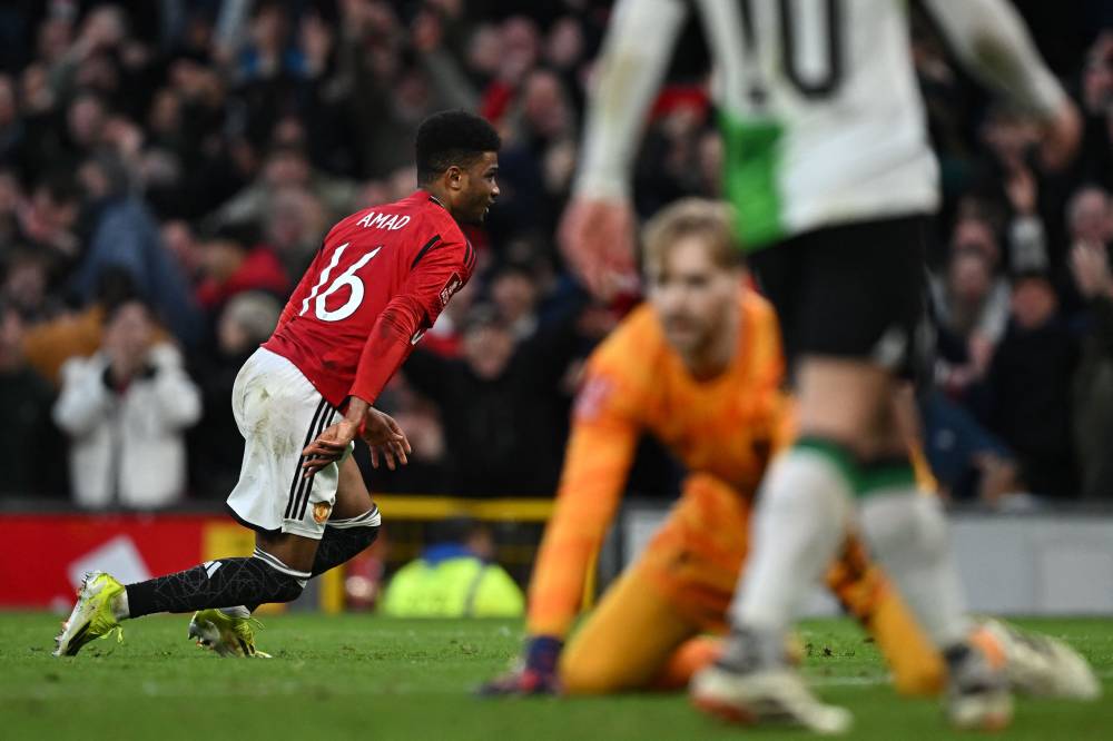 Manchester United's Ivorian midfielder Amad Diallo (L) starts to celebrate after scoring the winning goal in extra-time during the English FA Cup Quarter Final football match between Manchester United and Liverpool at Old Trafford in Manchester, north west England, on March 17, 2024. - Photo by AFP