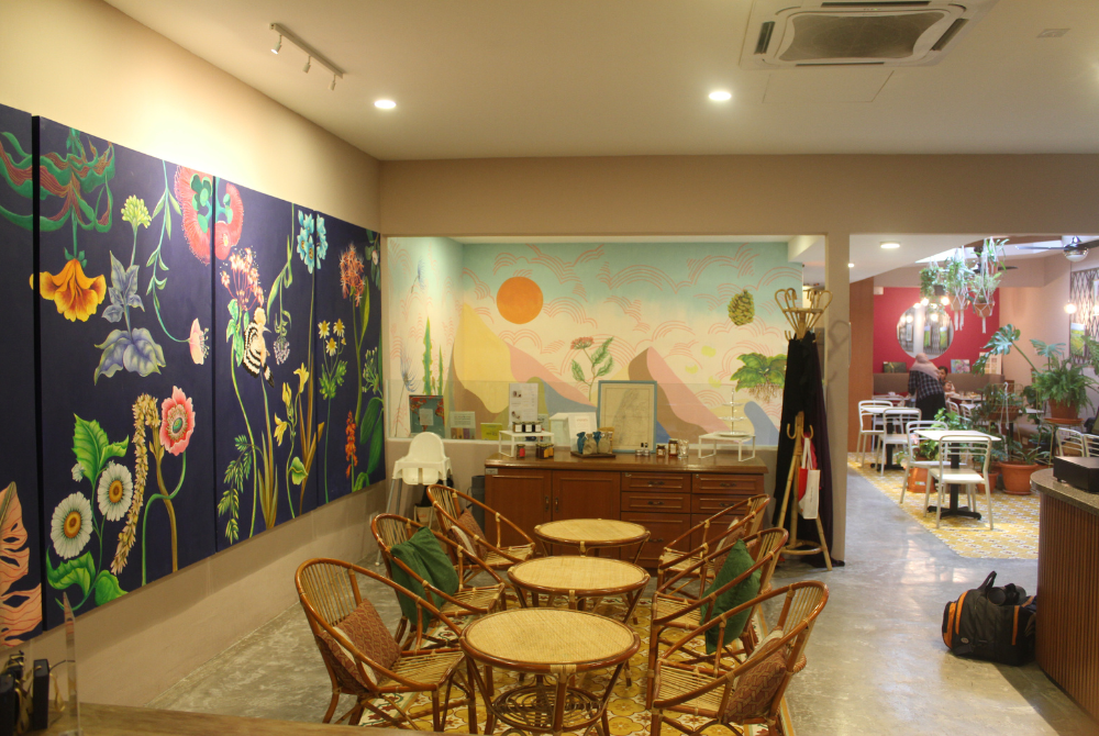 Customers are greeted with a burst of colors and a striking mural on the wall.