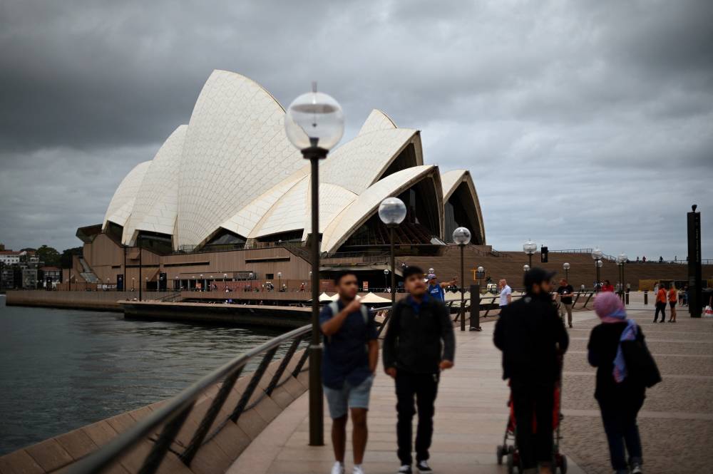 People visit the Opera House in Sydney on December 30, 2020, as authorities work to suppress a growing cluster of Covid-19 coronavirus cases in Australia's most populous city. (Photo by Saeed KHAN / AFP)