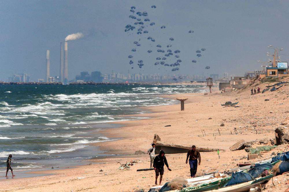 Humanitarian aid is dropped on the Gaza Strip, west of Gaza City, on March 25, 2024. - Photo by AFP