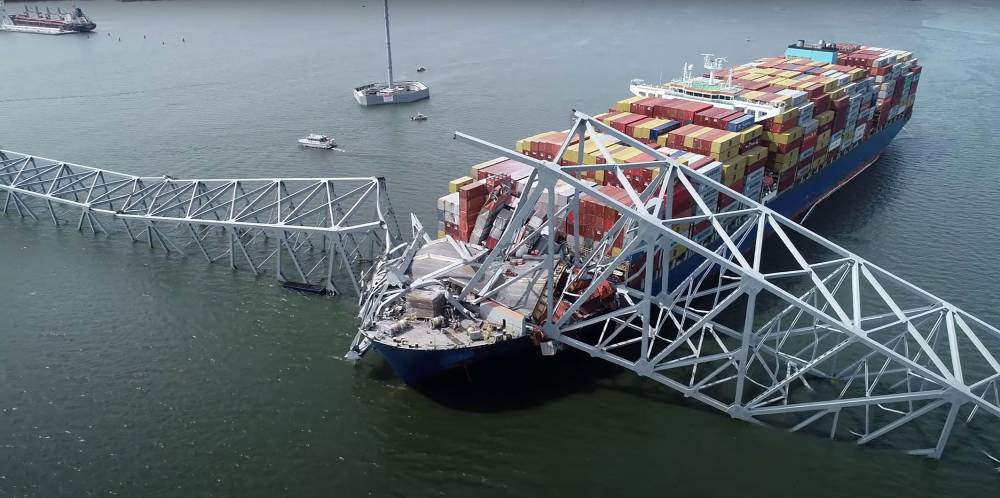 This handout screegrab courtesy of the National Transportation Safety Board taken on March 26, 2028, shows part of the steel frame of the Francis Scott Key Bridge sitting on top of the container ship Dali after the bridge collapsed in Baltimore, Maryland, on March 26, 2024. - Photo by AFP