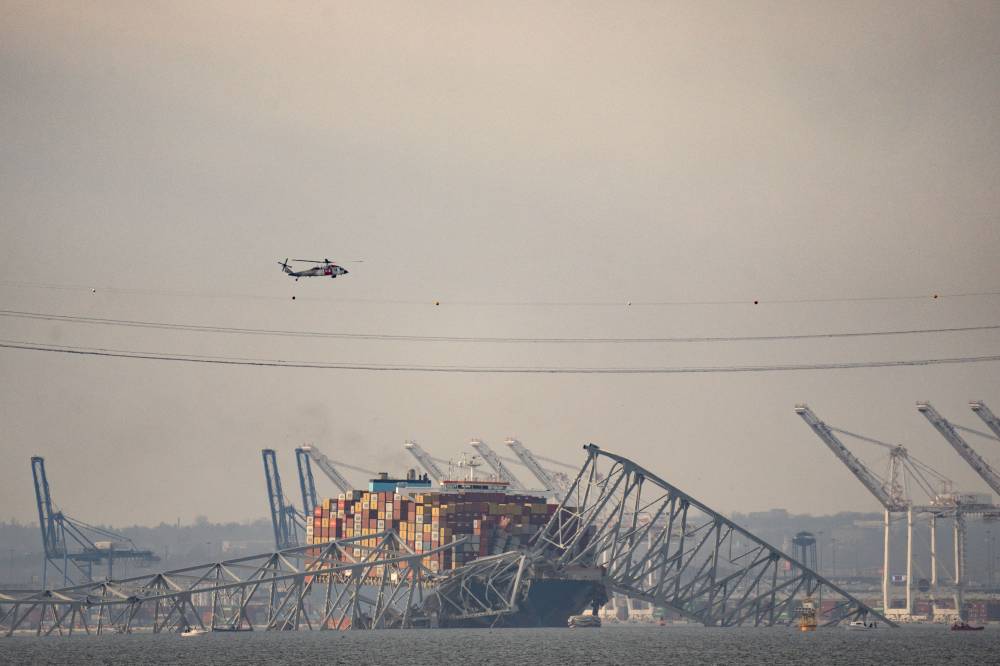 Part of the steel frame of the Francis Scott Key Bridge sits on top of the container ship Dali after the bridge collapsed in Baltimore, Maryland, on March 26, 2024. - (Photo by Kent Nishimura / AFP)